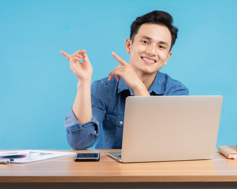 Image of young Asian buisnessman on blue background